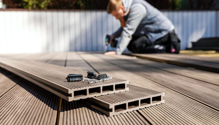 wpc terrace construction worker installing wood plastic compos
